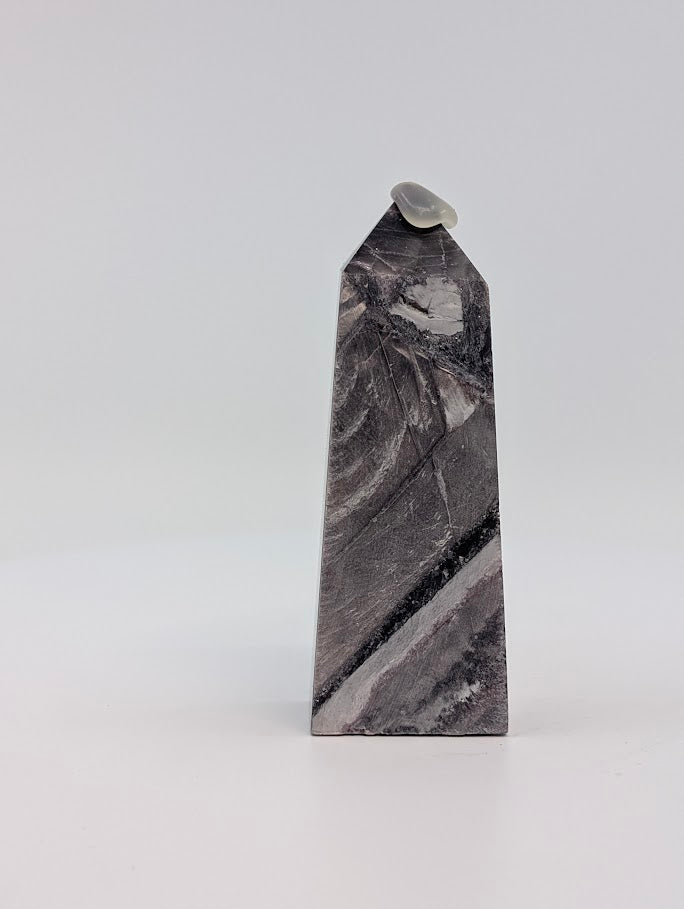 Angled front view of Lepidolite tower showing lilac-silver zoning and polished edges