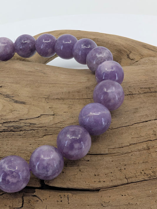 Close-up of Brazilian Lepidolite bracelet highlighting the uniform 8mm bead size and high-gloss polished luster.