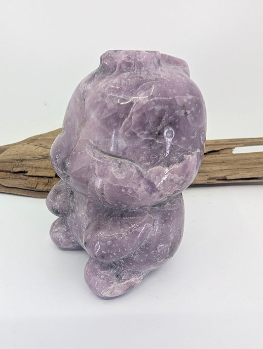 Side profile of the lavender Lepidolite dinosaur carving highlighting its smooth polished finish.