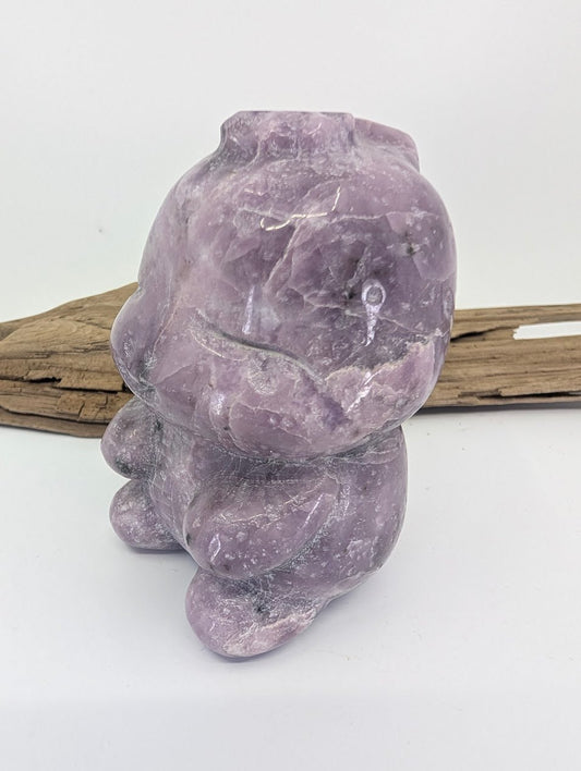 Side profile of the lavender Lepidolite dinosaur carving highlighting its smooth polished finish.