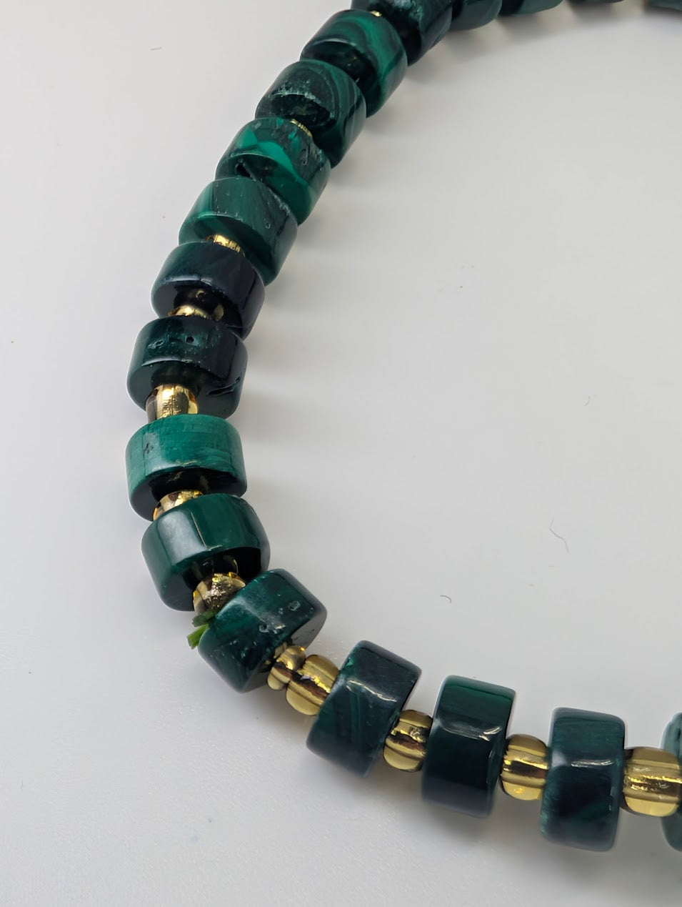 Angled detail shot of malachite cube bracelet highlighting polish and colour