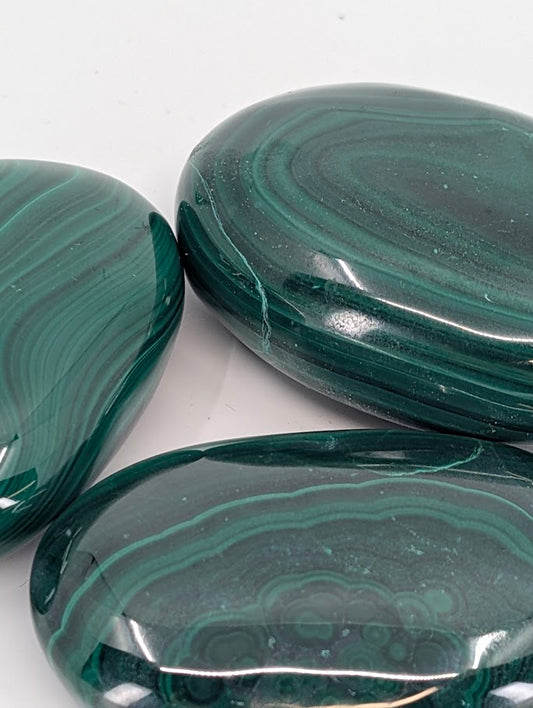 Close-up of Malachite Palm Stone displaying concentric patterning