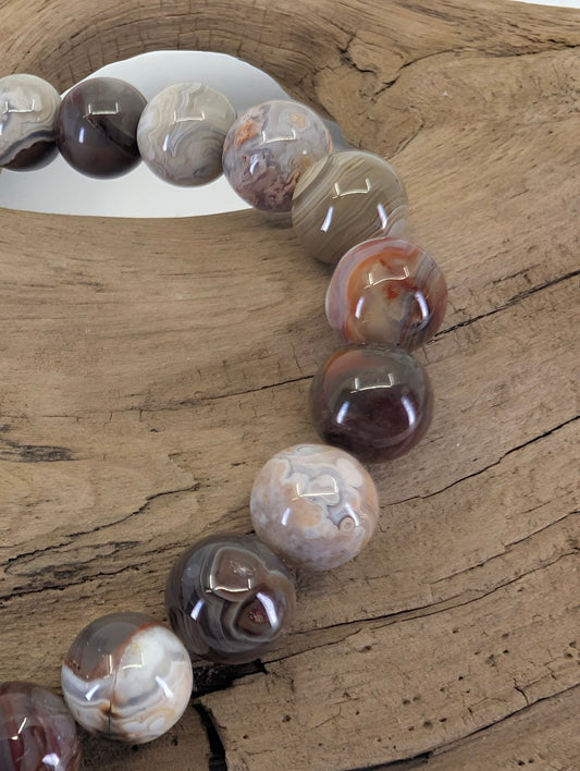 Close-up of 8mm Crazy Lace Agate beads highlighting the "festooned" lace-like patterns and earthy colors.