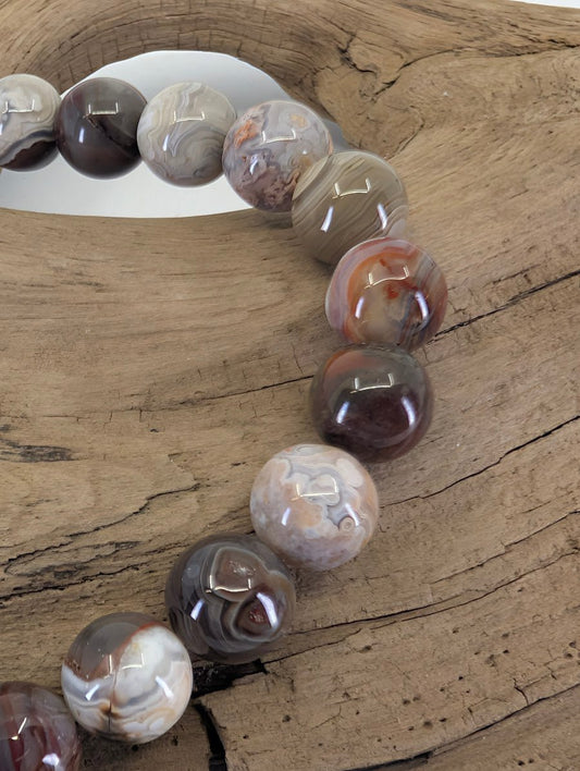 Close-up of 8mm Crazy Lace Agate beads highlighting the "festooned" lace-like patterns and earthy colors.