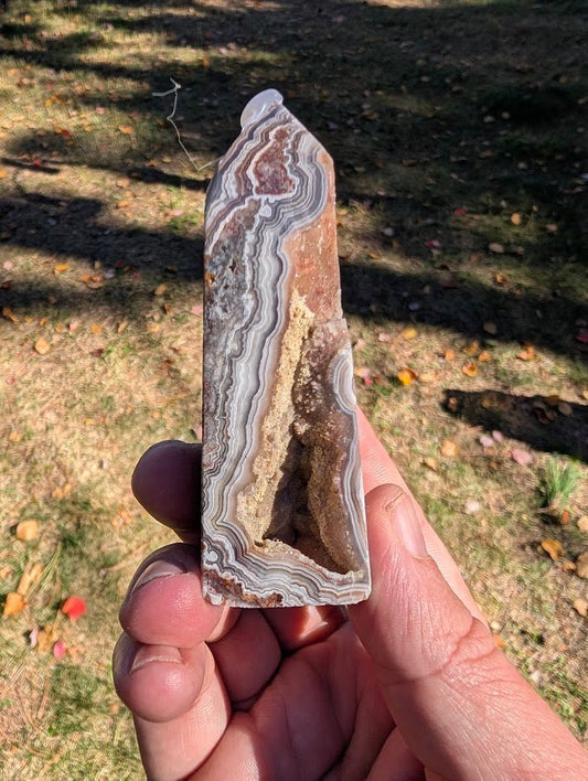 Mexican Lace Agate Tower side view – intricate lace banding in reds, greys, and creams