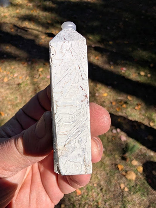 Mexican Lace Agate Tower #5 side view — white–cream banded chalcedony with quartz pockets