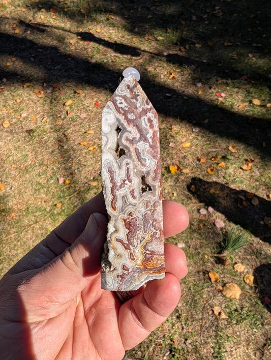 Mexican Lace Agate Tower #6 back view — ornate fortification banding with warm caramel and grey tones