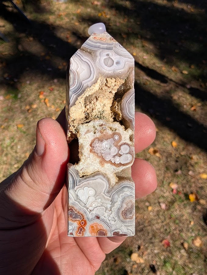 Mexican Lace Agate Tower #7 front view — 90 mm polished agate with large open vug and orbicular bands