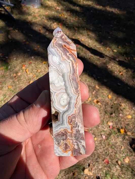 Mexican Lace Agate Tower #7 side view — flowing lace banding with warm red–orange accents