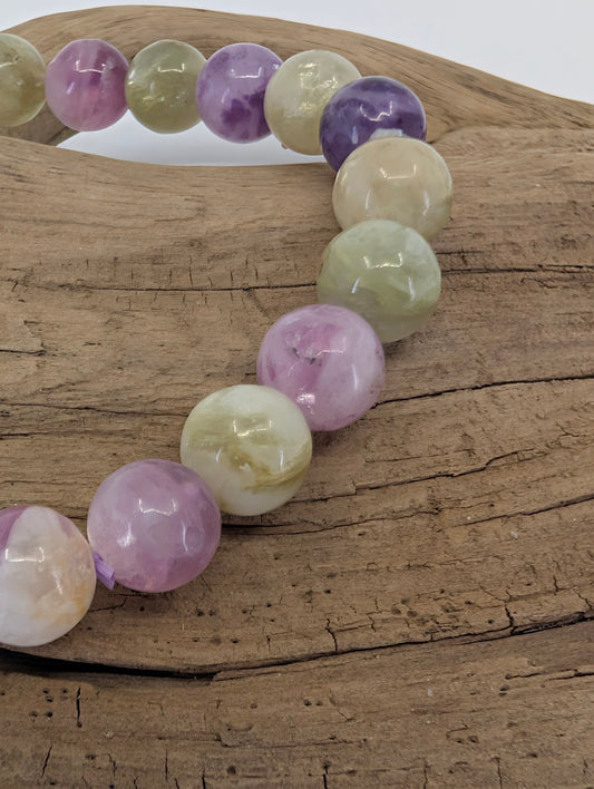 Close-up of 8mm mixed mica beads showing the transition between purple Lepidolite and translucent Muscovite.