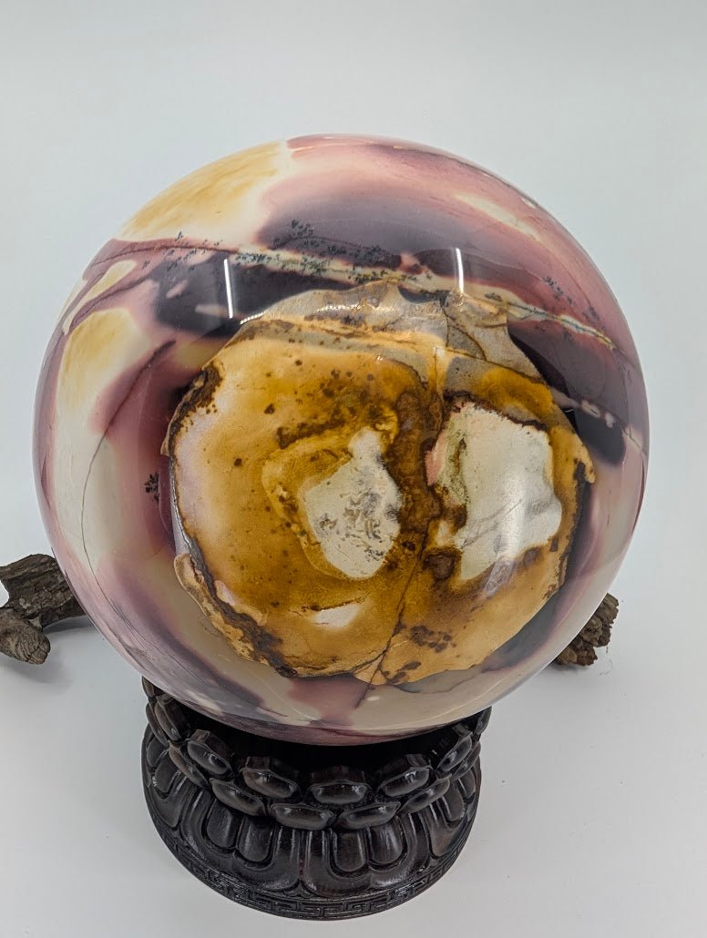 Close-up of the rare "eye" pattern formed by yellow brecciated sediment on a massive Mookaite sphere.