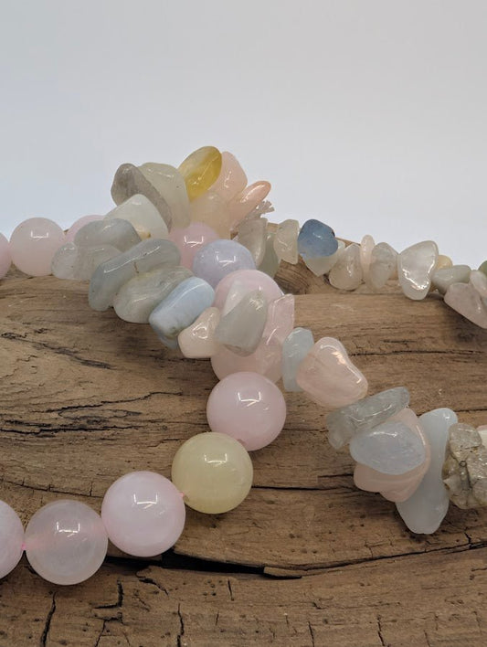 Close-up of morganite 8MM and chip bracelets showing blush, blue and honey hues