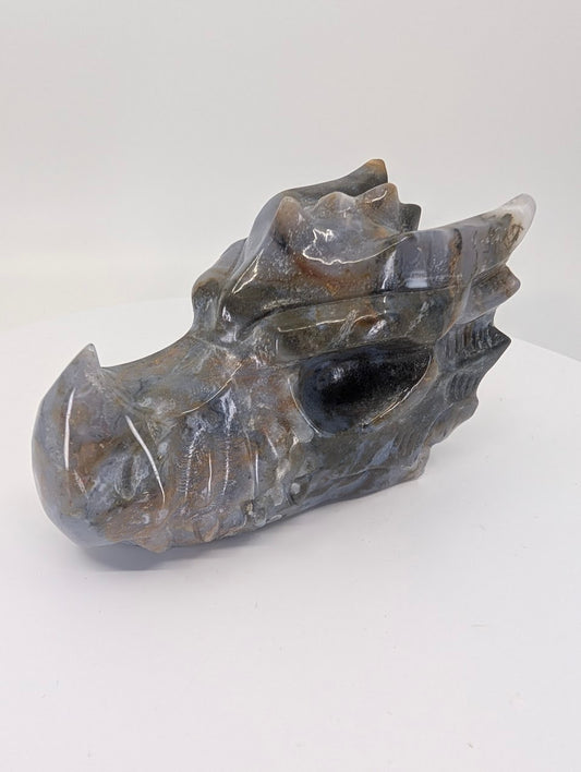 Side view of moss agate dragon head showing smoky chalcedony and moss patterns
