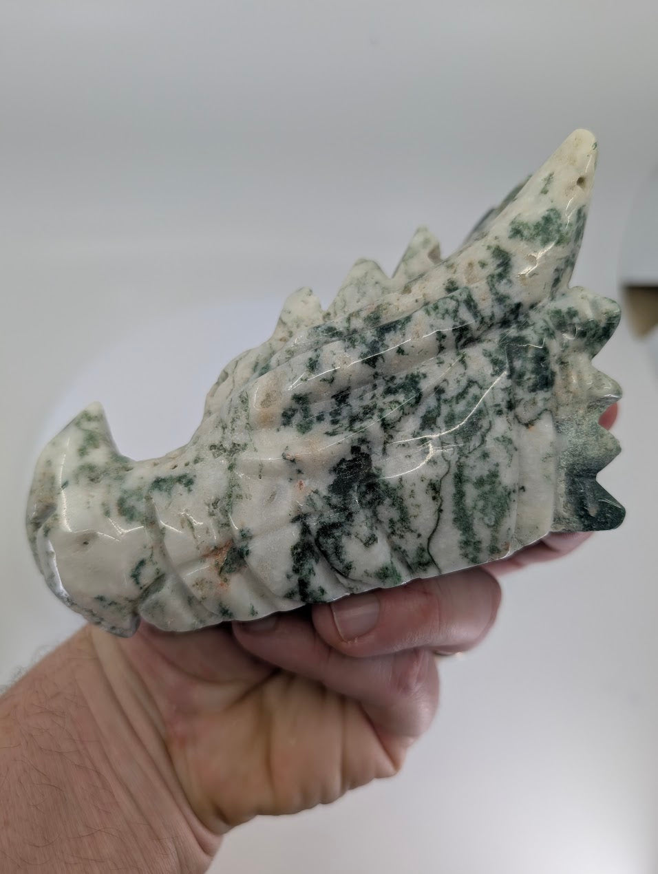 Handheld view showing carving details and chalcedony translucency