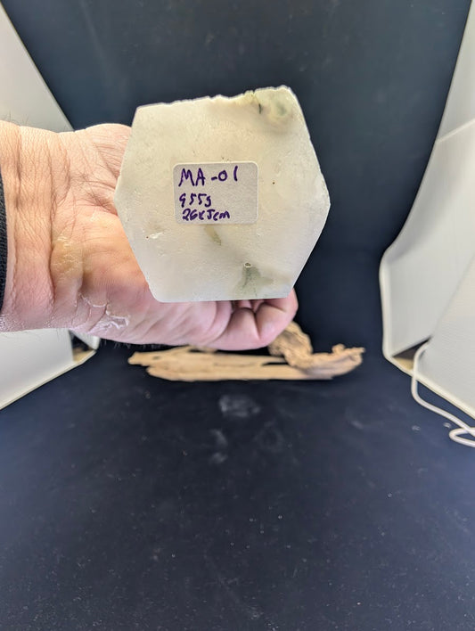 Underside of Moss Agate tower MA-01 showing specimen ID label and raw stone texture.