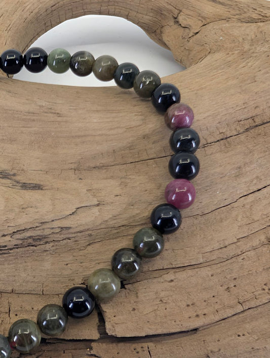 Close-up of 4.5mm Brazilian Tourmaline beads highlighting natural color transitions and high clarity.