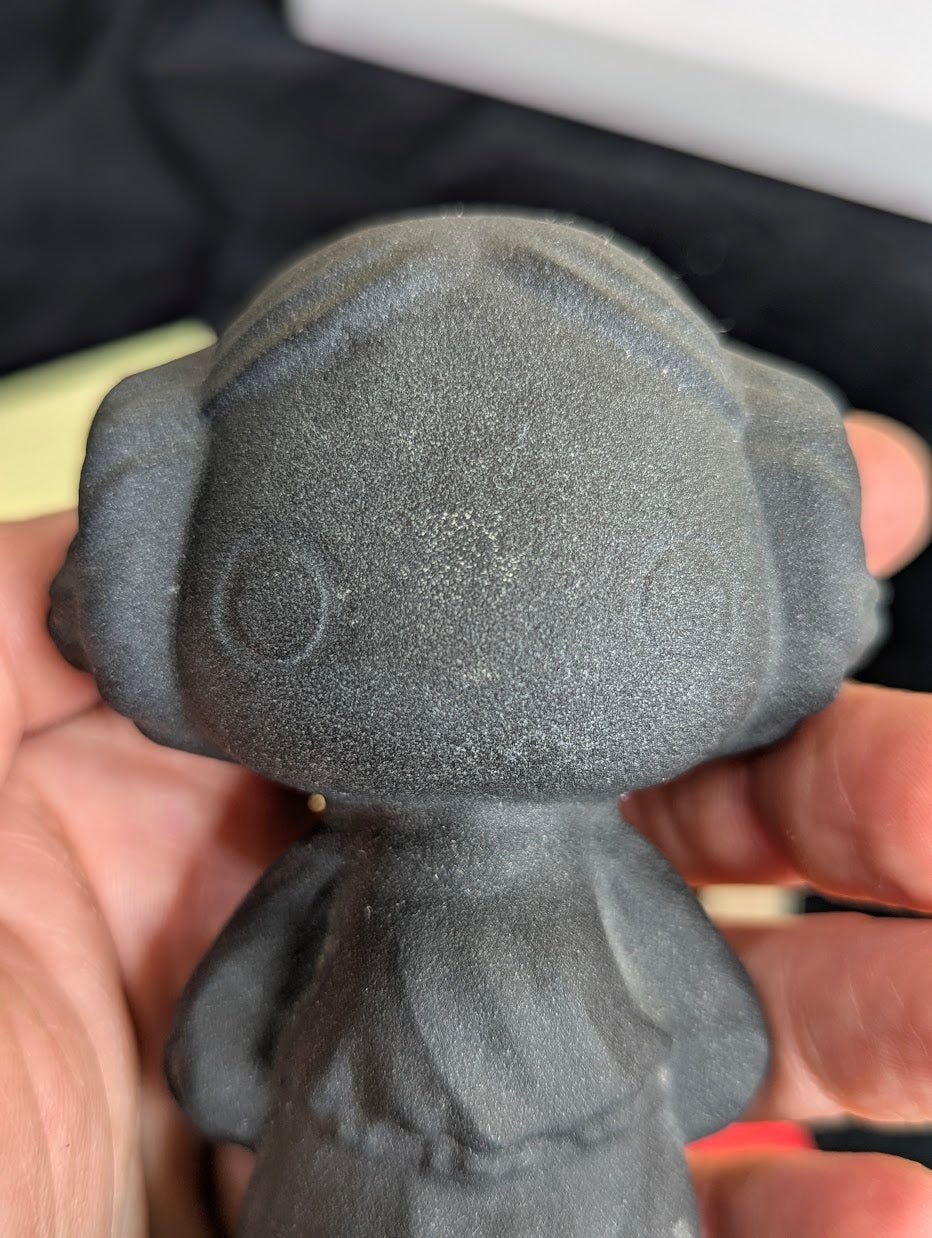 Princess Leia obsidian carving with scale reference.