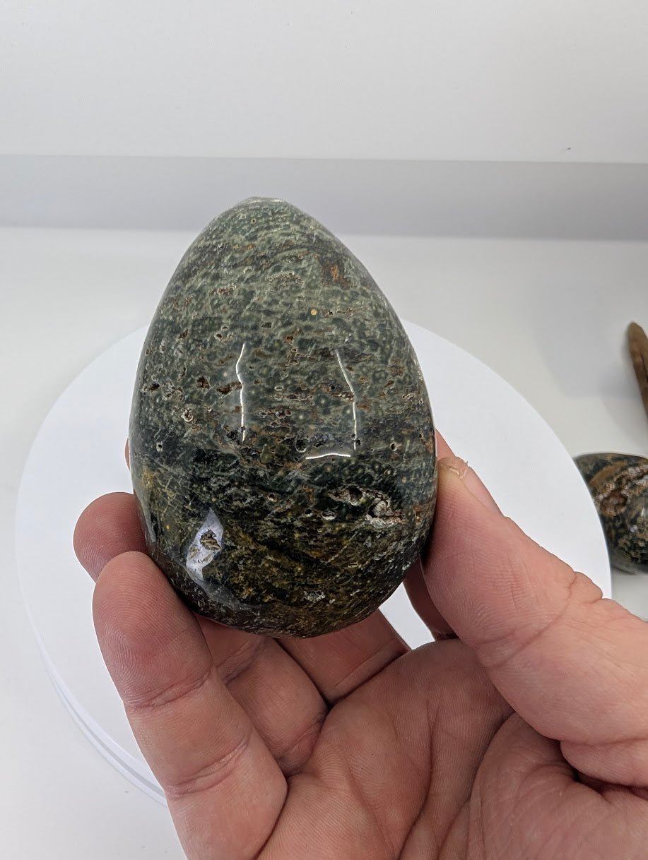 Ocean jasper egg from Madagascar, Piece A, showing orbicular patterning and natural texture in hand