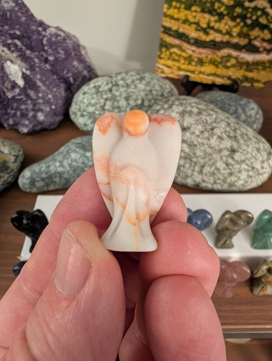 tiny-angel-carving-orange-calcite-3cm-handheld-scale-reference