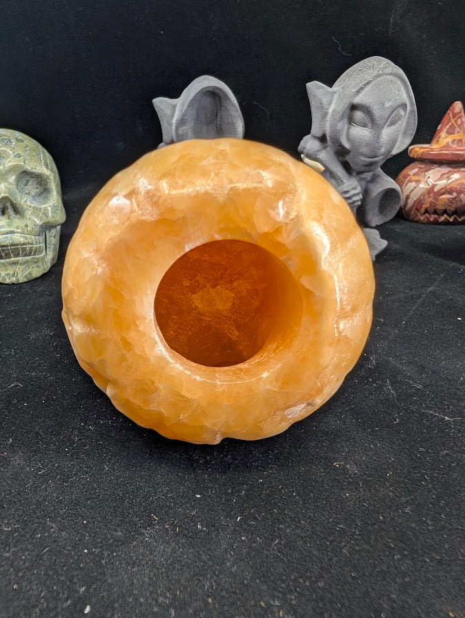 Orange Calcite Pumpkin with Witch Hat – Bottom View showing hollow interior and translucence