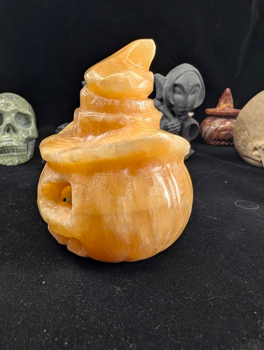 Orange Calcite Pumpkin with Witch Hat – Side Profile showing rounded form and hat