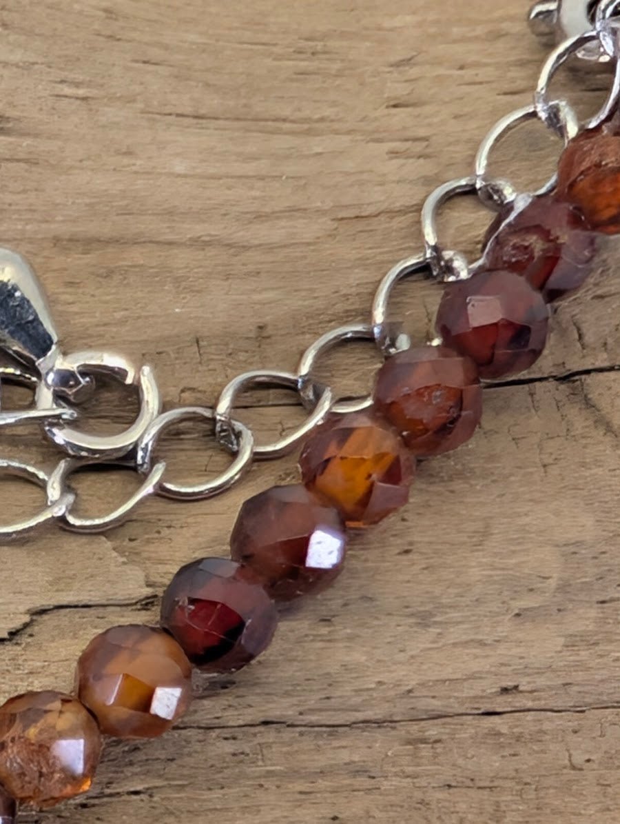 Macro view of 3mm faceted Peach Garnet beads highlighting the precision diamond-cut and natural clarity.