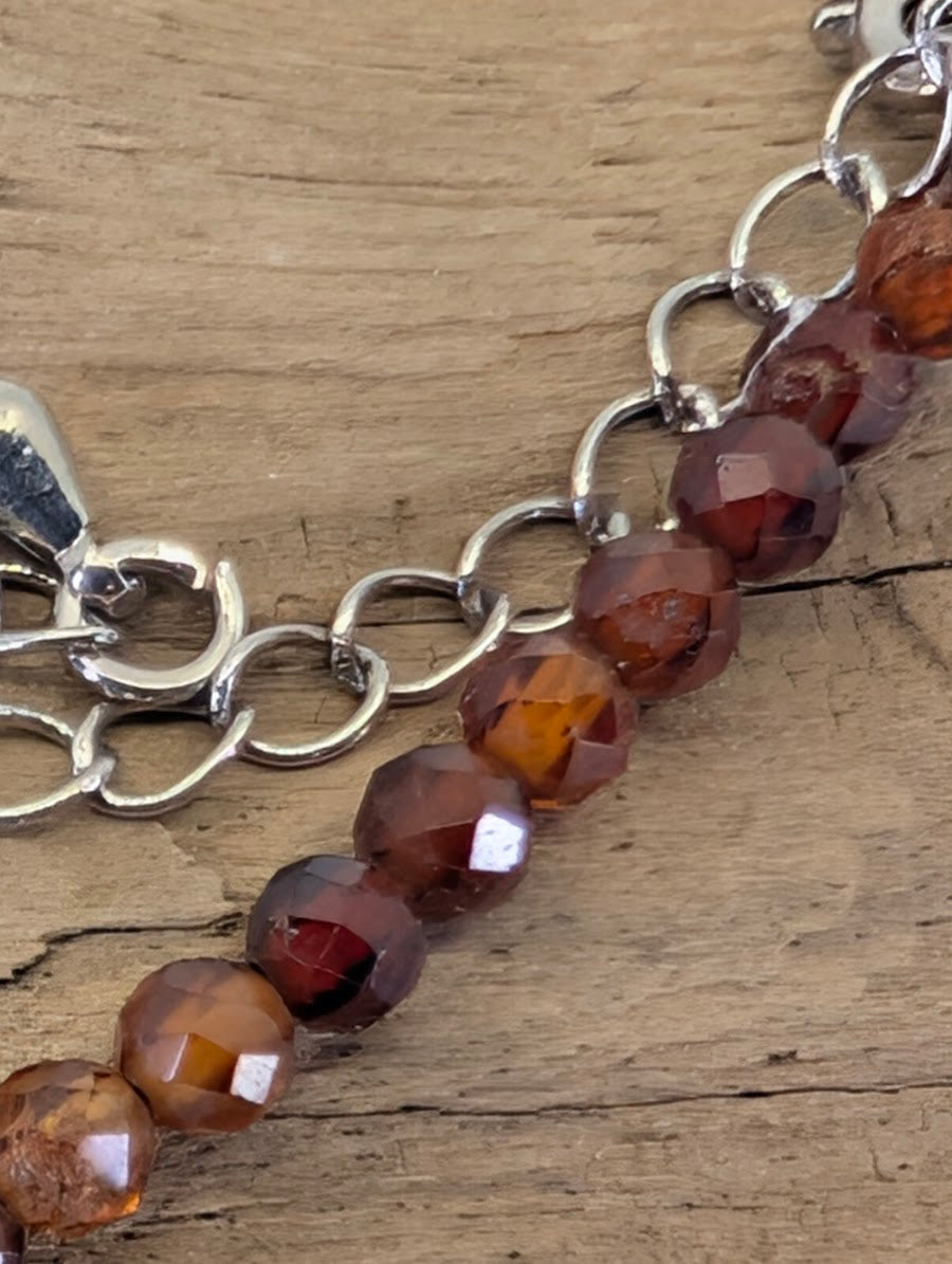 Macro view of 3mm faceted Peach Garnet beads highlighting the precision diamond-cut and natural clarity.