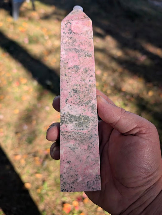 Front view of Peruvian rhodonite tower #2 showing pink base with dark manganese inclusions