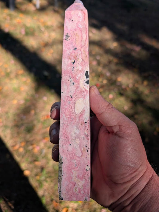 Front view of tall Peruvian rhodonite tower #4 showing flowing pink banding and cream patches