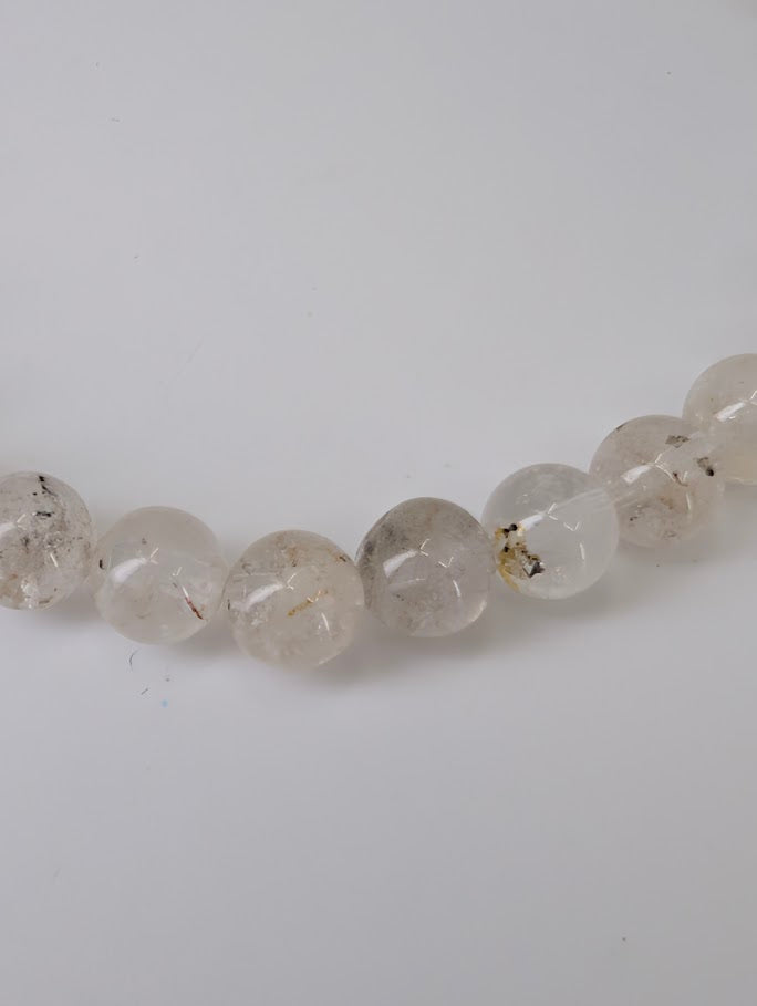 Petroleum Quartz Bracelet detail showing visible oil and carbon inclusions in clear quartz beads