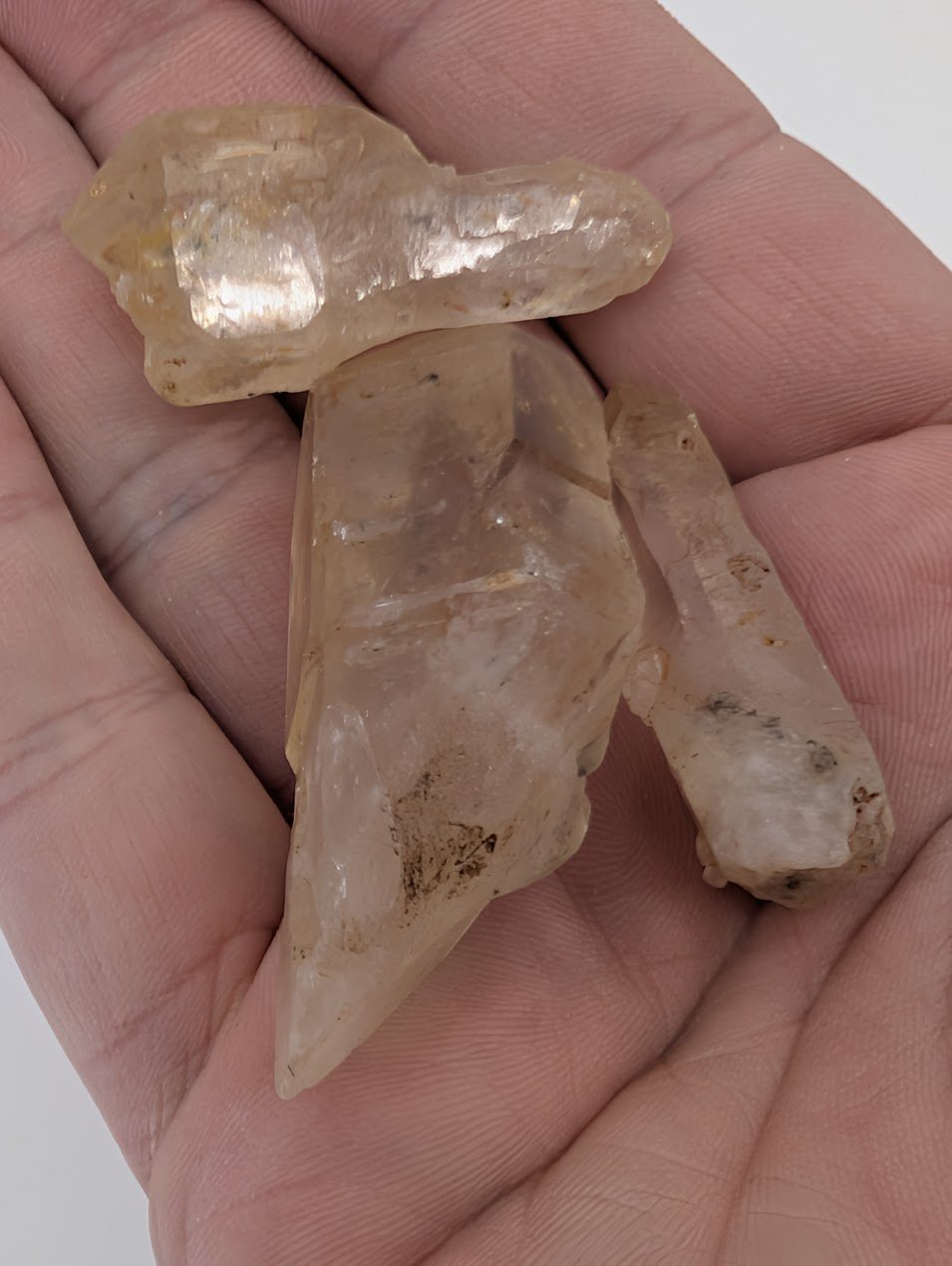 Handheld Petroleum Quartz crystal showing clarity and champagne tone