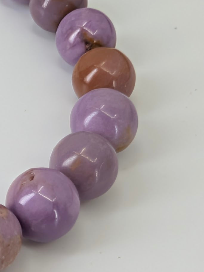 Close-up side angle of Phosphosiderite bracelet emphasizing high-gloss polish and bead uniformity