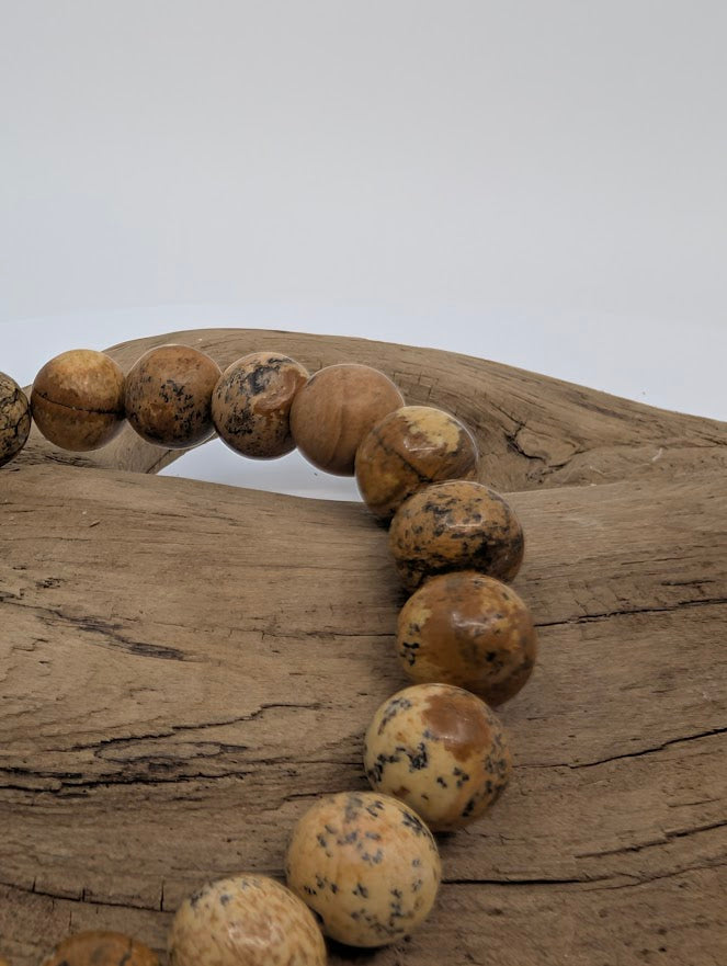 Close-up of polished 8mm Picture Jasper beads showing scenic banding and speckling