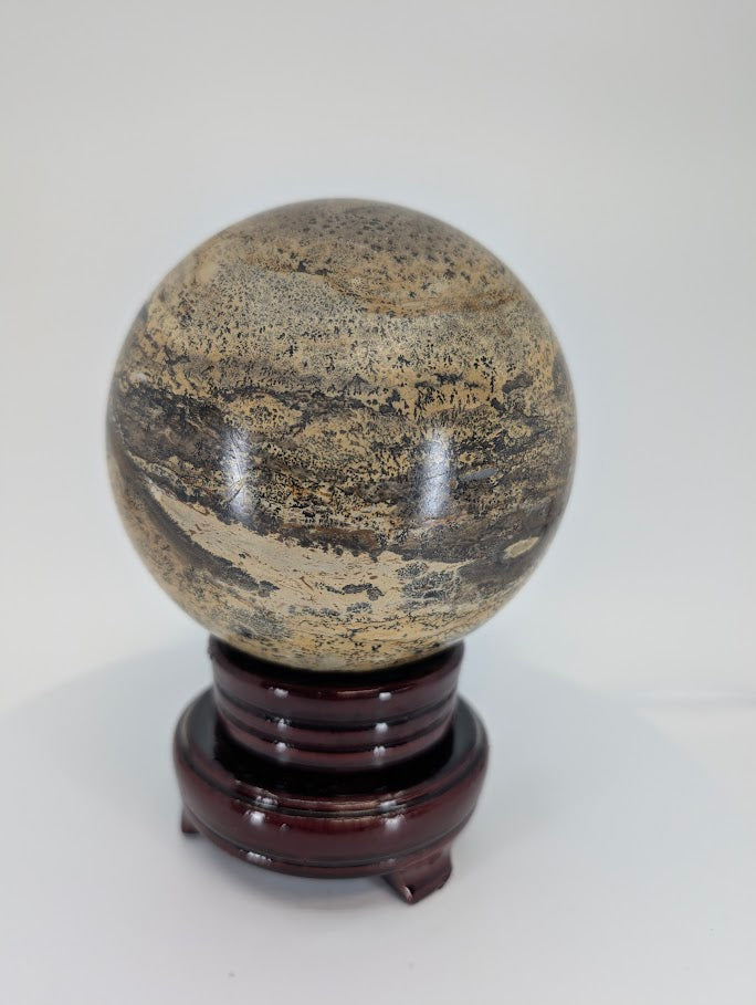 Angled view of Picture Jasper sphere highlighting landscape-like layering