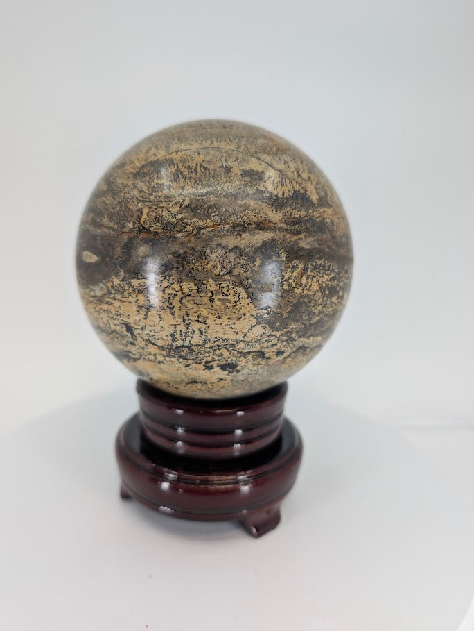 Detailed close-up of Picture Jasper sphere showing iron oxide textures