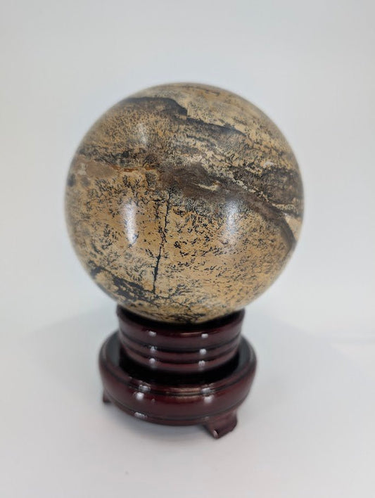 Side view of Picture Jasper sphere with intricate dark dendritic pattern