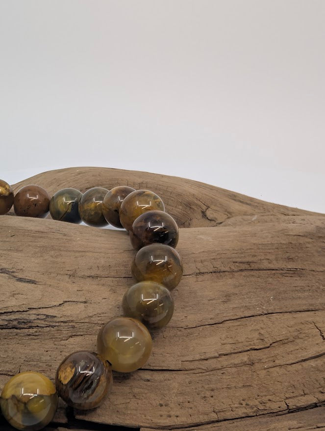 Close-up of Pietersite beads showing bronze and charcoal swirls