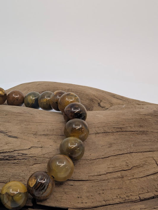 Close-up of Pietersite beads showing bronze and charcoal swirls