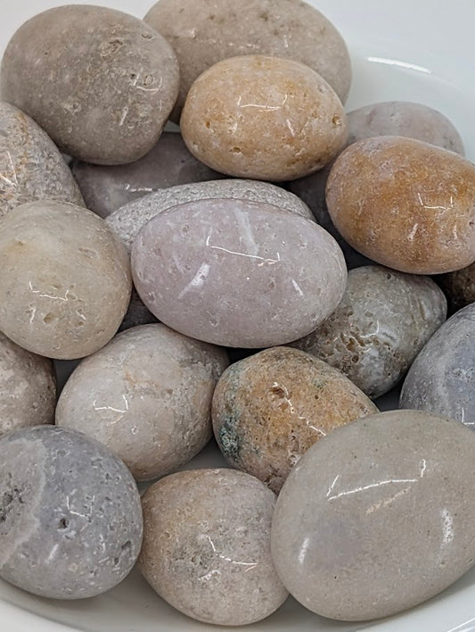 Close-up of Pink Amethyst tumbled stones showing pastel tones and inclusions