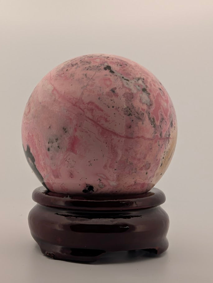 Front view showing deep pink and cream marbling with black inclusions