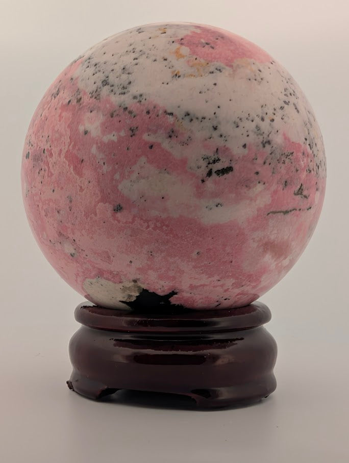 Front view showing pink and white banding with black inclusions