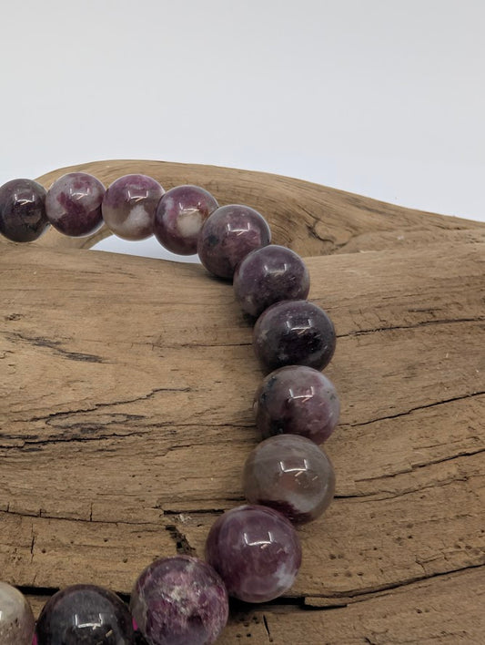 Close-up of Pink Tourmaline beads showing berry hues and quartz matrix