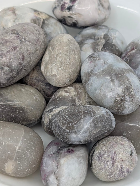 Close-up of Pink Tourmaline in Quartz tumbled stones showing pink veining