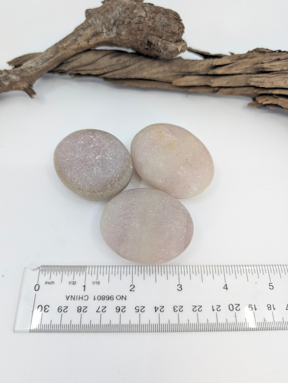 Pistachio Calcite palm stones with ruler for size reference