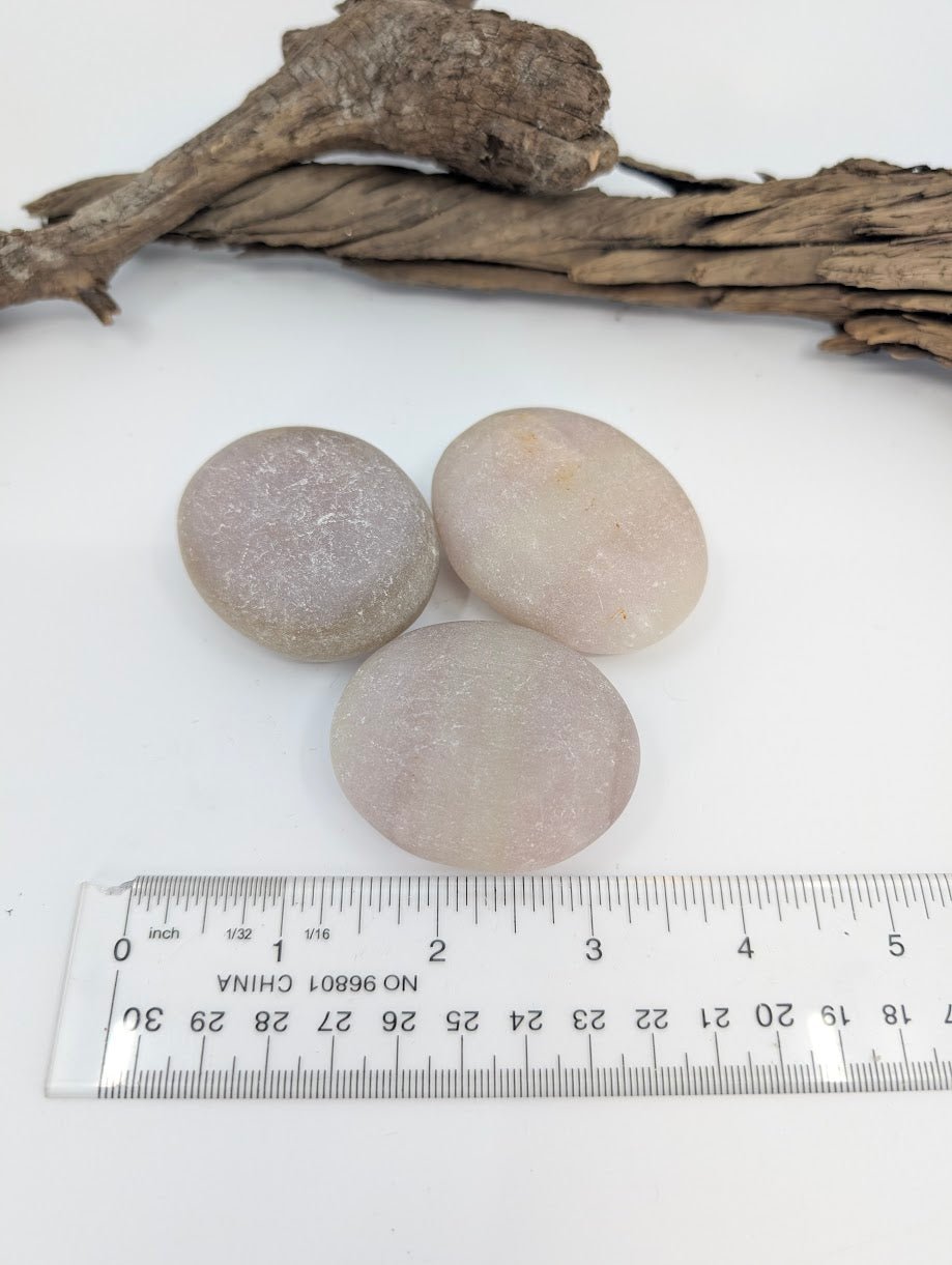 Pistachio Calcite palm stones with ruler for size reference