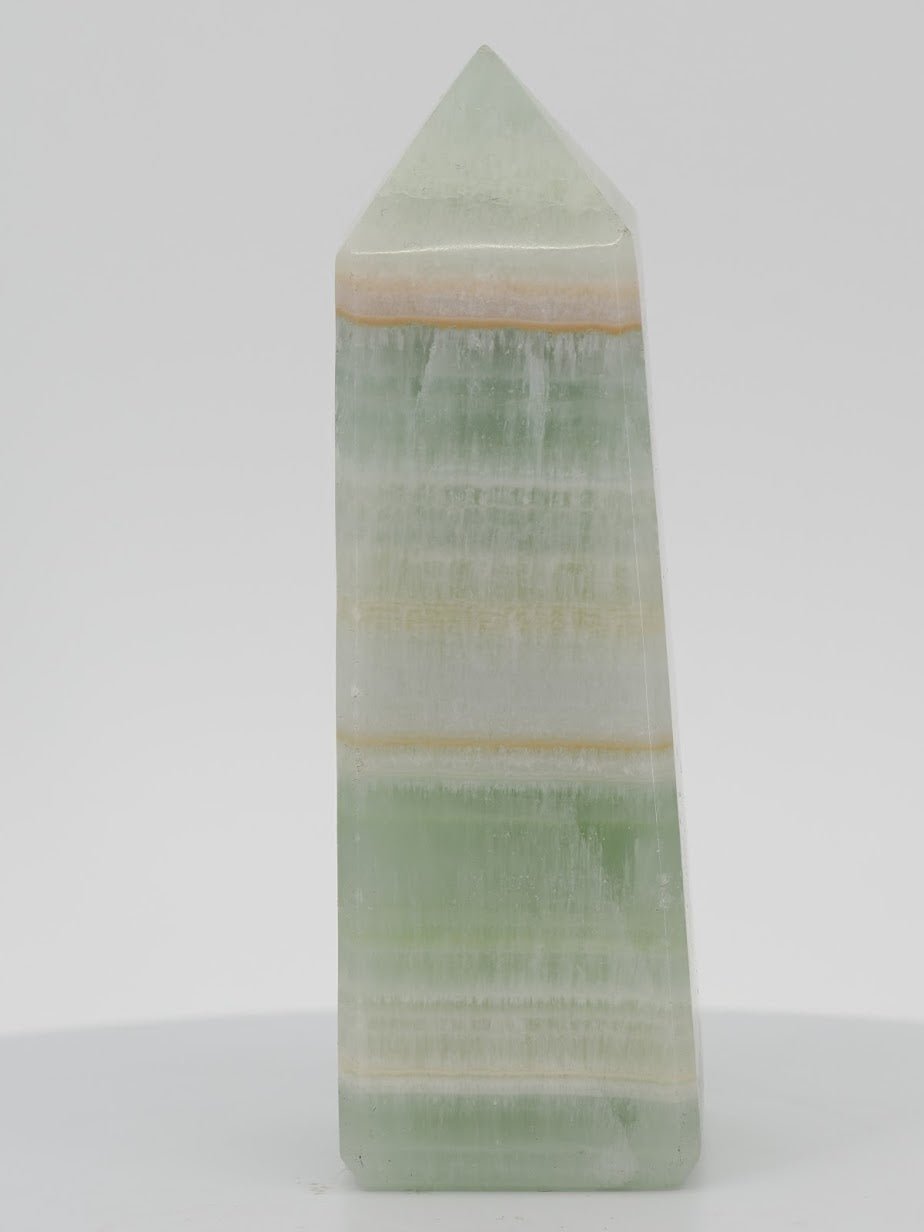 Polished Pistachio Banded Calcite tower featuring vibrant mint green, white aragonite, and thin orange mineral bands.