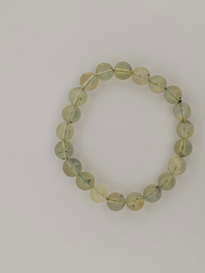 8mm Prehnite stretch bracelet, top-down, luminous apple-green beads with inclusions.
