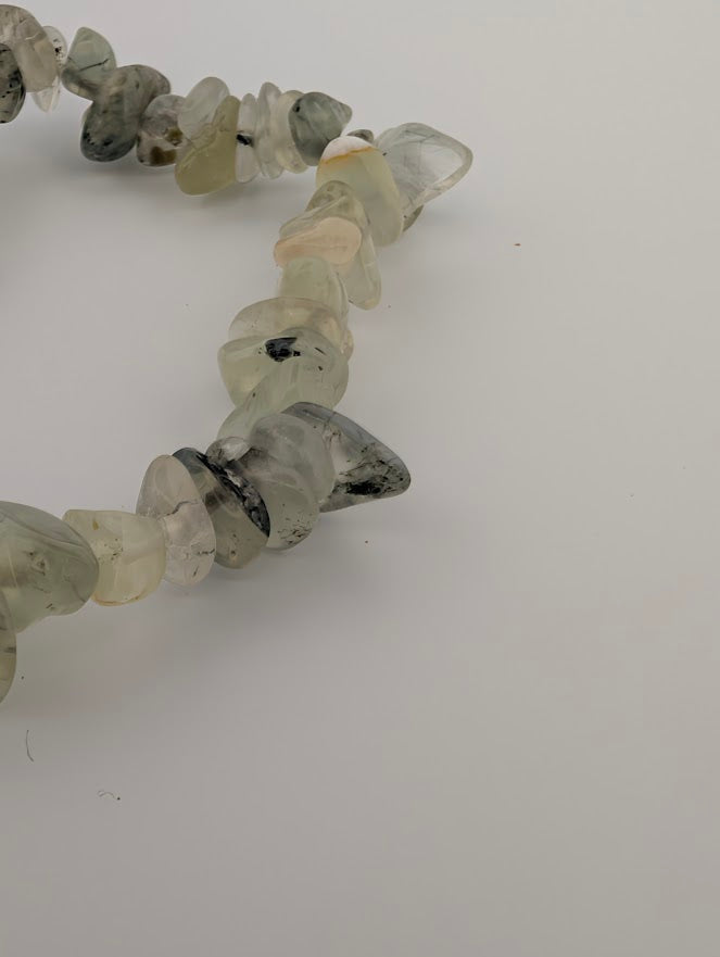Closeup of Prehnite chip bracelet showing smooth tumbled chips and organic shapes.