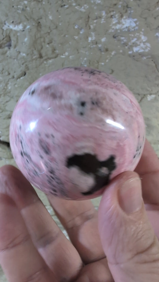 Video of 60mm 395g of polished pink rhodonite sphere with bold contrast