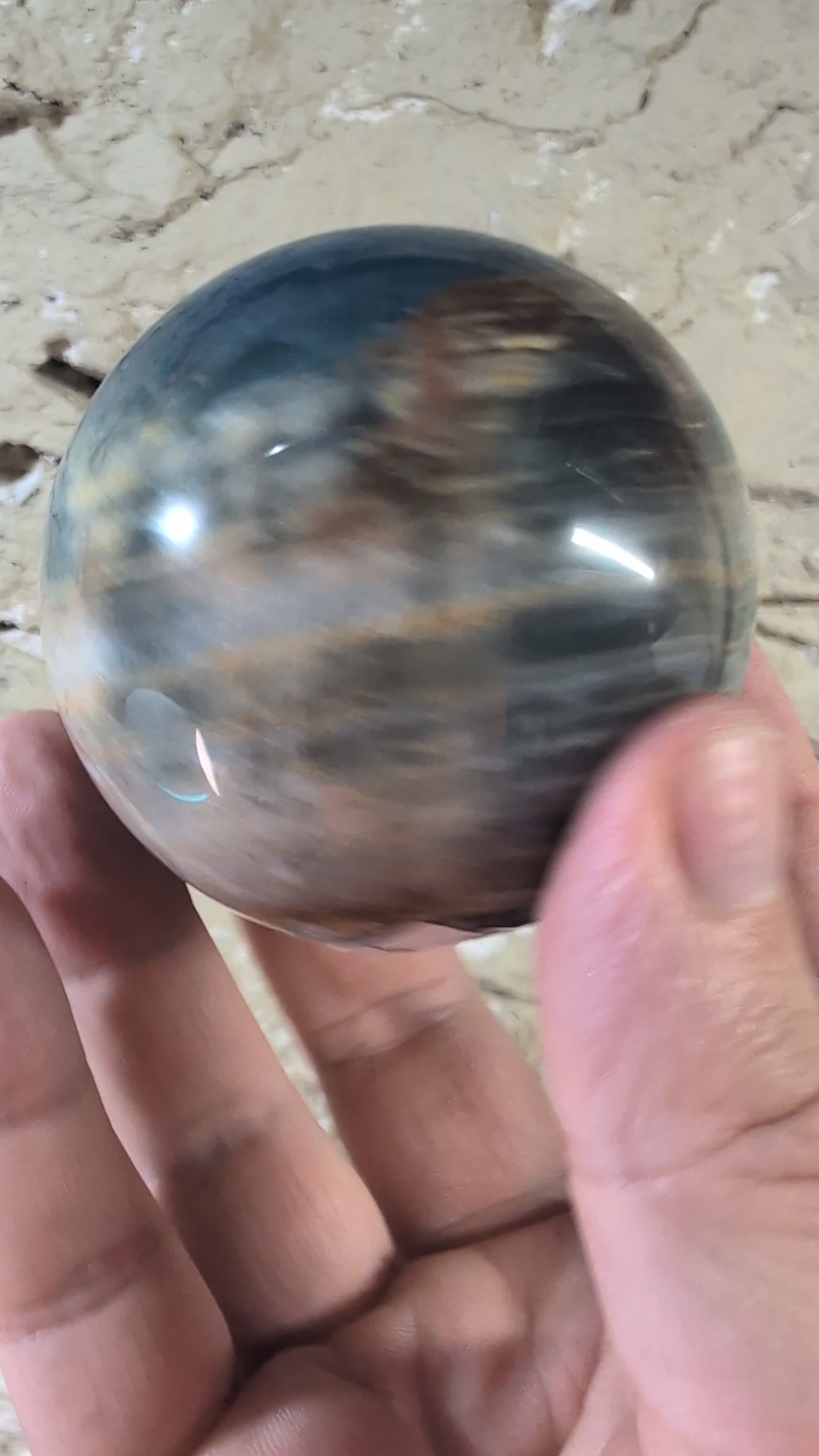 video of 63mm blue onyx sphere with banded patterns